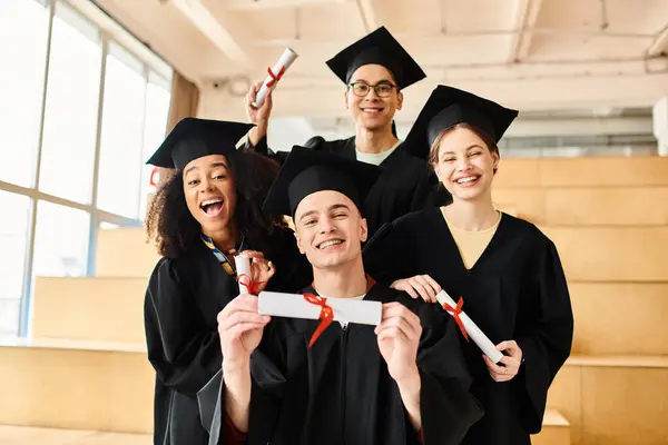 stock photo group students different backgrounds donning graduation gowns caps joyfully posing